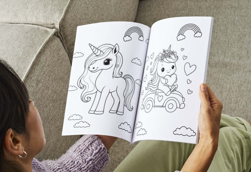 Person coloring a unicorn and fairy illustration in a coloring book.